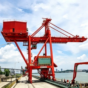 The ship to shore container crane is a container handling crane installed at large dockside for loading and unloading ship-borne containers to the container trucks. The dockside container crane is composed of a supporting frame that can travel on a rail track. Instead of a hook, the cranes are equipped with a specialized spreader which can be locked on the container.